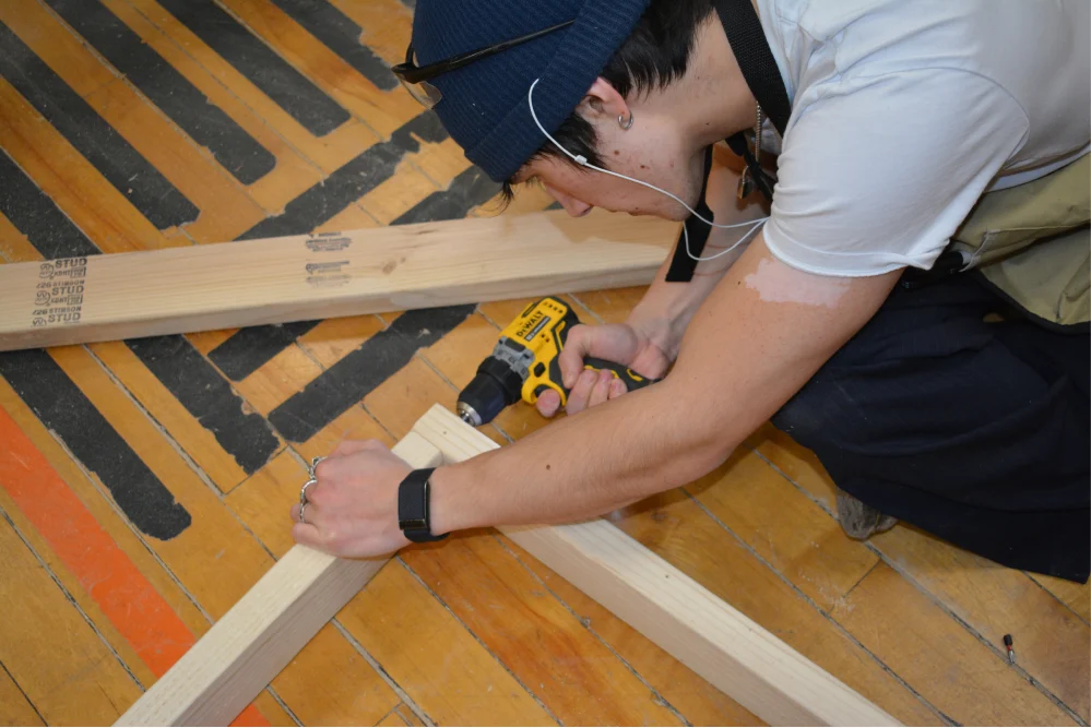 Driving decking screws into the 2 x 4 frame
