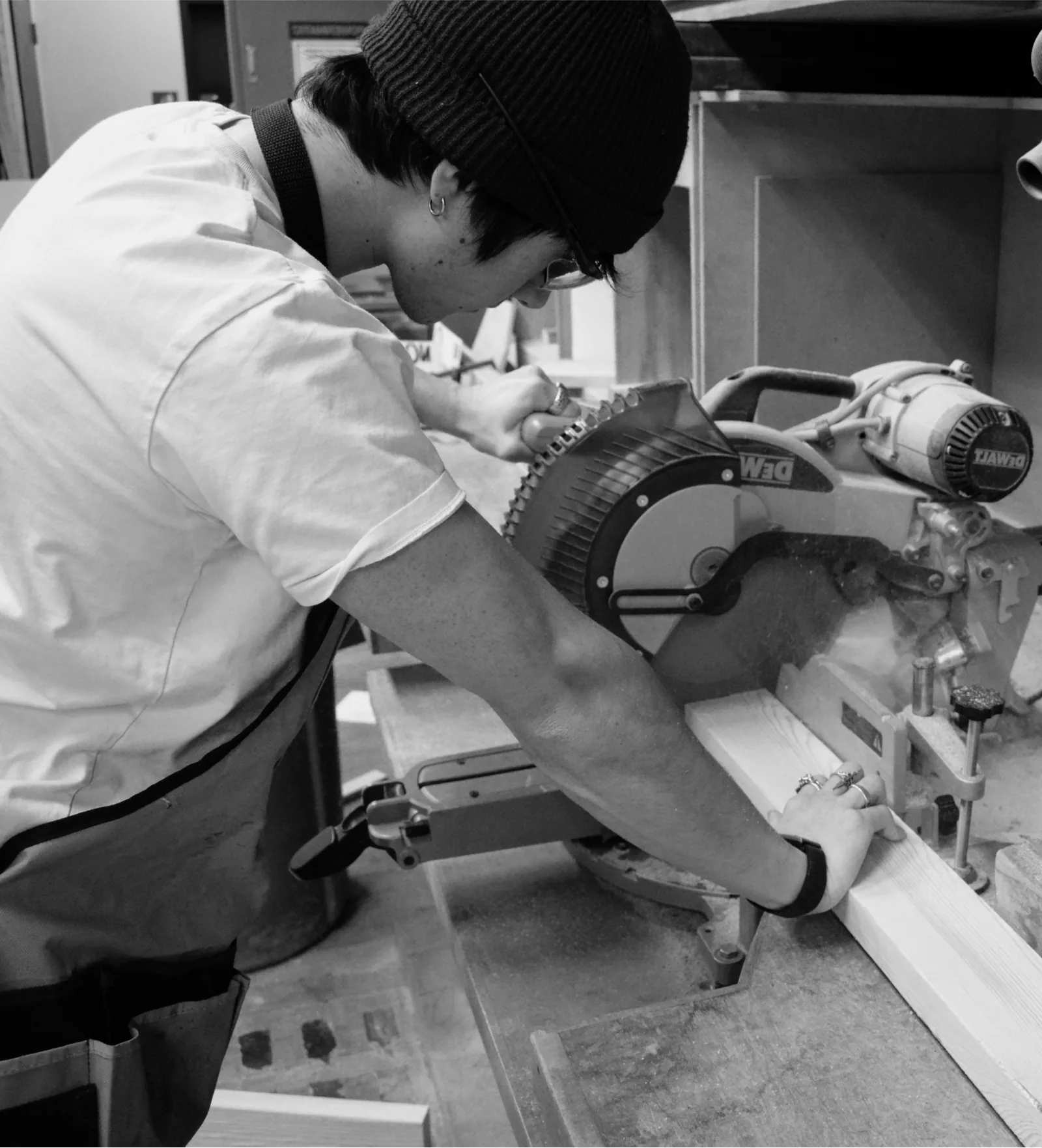 Josh White cutting timber on a mitre saw in the RISD workshop